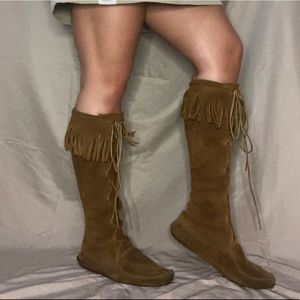 Minnetonka moccasin tan fringe knee-high boots.